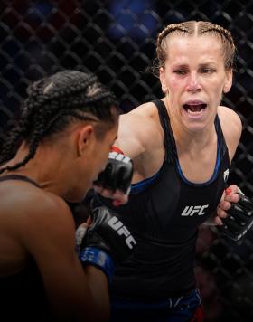 Katlyn Chookagian punches Viviane Araujo of Brazil in their women's flyweight bout during the UFC 262 event at Toyota Center on May 15, 2021 in Houston, Texas. (Photo by Josh Hedges/Zuffa LLC)