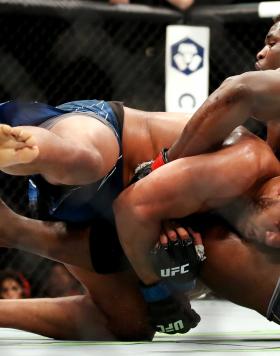 Francis Ngannou of Cameroon (right) tackles Ciryl Gane of France in their heavyweight title fight during the UFC 270 event at Honda Center on January 22, 2022 in Anaheim, California. (Photo by Katelyn Mulcahy/Getty Images)