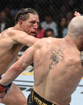 Brian Ortega punches Alexander Volkanovski of Australia in their UFC featherweight championship fight during the UFC 266 event