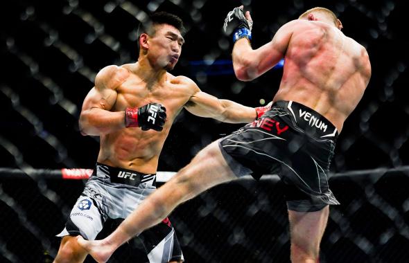 Song Yadong lands a punch on Casey Kenney in the 2nd round during their Bantamweight fight at Toyota Center on July 7, 2021 in Houston, Texas. (Photo by Alex Bierens de Haan/Getty Images)