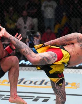 Marlon Vera of Ecuador kicks Rob Font in a bantamweight fight during the UFC Fight Night event at UFC APEX