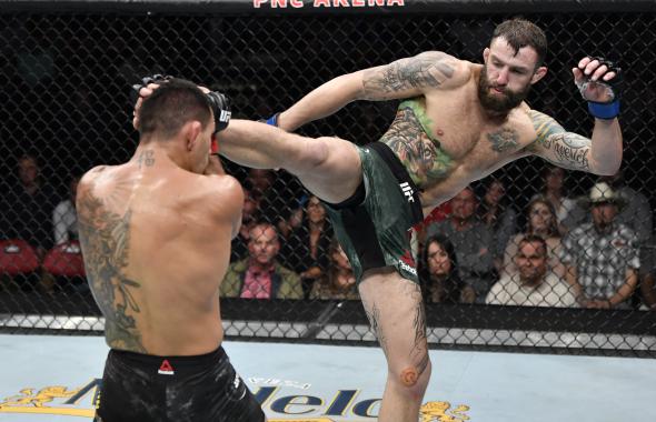 Michael Chiesa kicks Rafael Dos Anjos of Brazil in their welterweight fight during the UFC Fight Night event at PNC Arena on January 25, 2020 in Raleigh, North Carolina. (Photo by Jeff Bottari/Zuffa LLC)