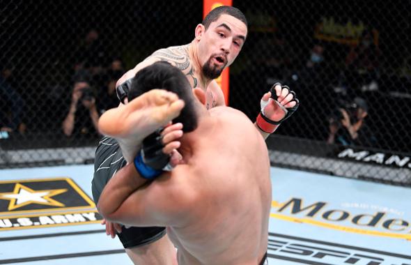 Robert Whittaker of Australia kicks Kelvin Gastelum in a middleweight fight during the UFC Fight Night event at UFC APEX on April 17, 2021 in Las Vegas, Nevada. (Photo by Chris Unger/Zuffa LLC)