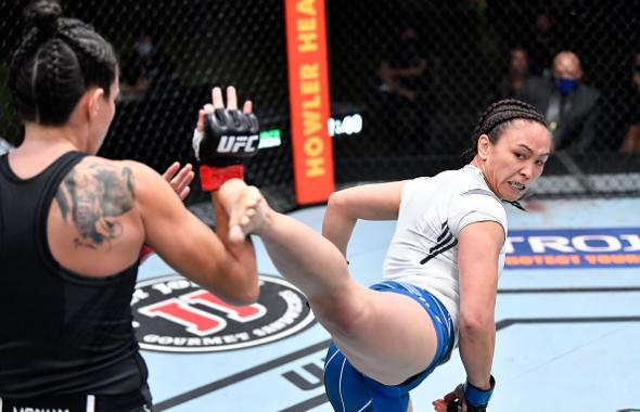 Michelle Waterson kicks Marina Rodriguez of Brazil in a flyweight fight during the UFC Fight Night event at UFC APEX on May 08, 2021 in Las Vegas, Nevada. (Photo by Chris Unger/Zuffa LLC)