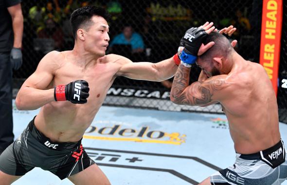 'The Korean Zombie' Chan Sung Jung of South Korea punches Dan Ige in a featherweight bout during the UFC Fight Night event at UFC APEX on June 19, 2021 in Las Vegas, Nevada. (Photo by Chris Unger/Zuffa LLC)