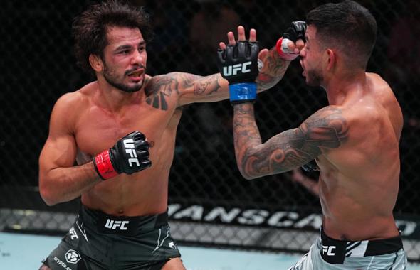 Alexandre Pantoja of Brazil punches Brandon Royval in a flyweight fight during the UFC Fight Night event at UFC APEX on August 21, 2021 in Las Vegas, Nevada. (Photo by Chris Unger/Zuffa LLC)