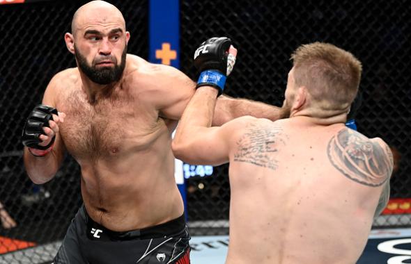  Shamil Abdurakhimov of Russia punches Chris Daukaus in their heavyweight fight during the UFC 266 event on September 25, 2021 in Las Vegas, Nevada. (Photo by Jeff Bottari/Zuffa LLC)