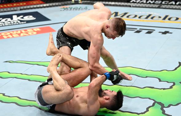  Dan Hooker of New Zealand punches Nasrat Haqparast of Germany in their lightweight fight during the UFC 266 event on September 25, 2021 in Las Vegas, Nevada. (Photo by Jeff Bottari/Zuffa LLC)