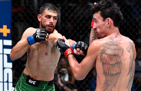 Yair Rodriguez of Mexico punches Max Holloway in a featherweight fight during the UFC Fight Night event at UFC APEX on November 13, 2021 in Las Vegas, Nevada. (Photo by Chris Unger/Zuffa LLC)