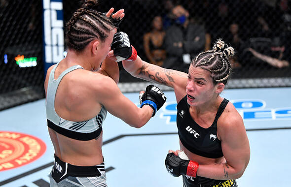 Luana Pinheiro of Brazil punches Sam Hughes in a strawweight fight during the UFC Fight Night event at UFC APEX on November 20, 2021 in Las Vegas, Nevada. (Photo by Chris Unger/Zuffa LLC)