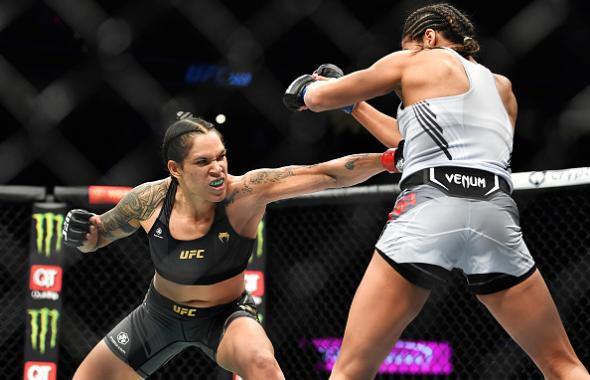 Amanda Nunes of Brazil punches Julianna Pena in their UFC bantamweight championship bout during the UFC 269 on December 11, 2021 in Las Vegas, Nevada. (Photo by Chris Unger/Zuffa LLC)