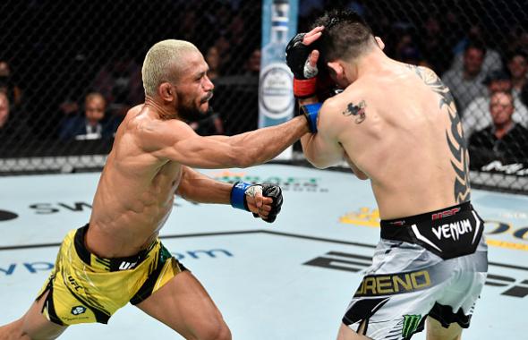 Deiveson Figueiredo of Brazil punches Brandon Moreno of Mexico in their UFC flyweight championship fight during the UFC 270 event at Honda Center on January 22, 2022 in Anaheim, California. (Photo by Chris Unger/Zuffa LLC)