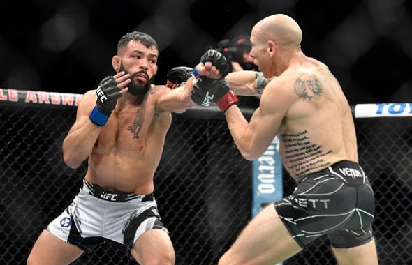 Dan Ige punches Josh Emmett in their featherweight bout during UFC 269 at T-Mobile Arena on December 11, 2021 in Las Vegas, Nevada. (Photo by Chris Unger/Zuffa LLC)