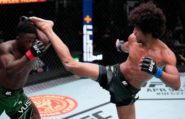 Alex Caceres kicks Sodiq Yusuff of Nigeria in their featherweight fight during the UFC Fight Night event at UFC APEX on March 12, 2022 in Las Vegas, Nevada. (Photo by Chris Unger/Zuffa LLC)