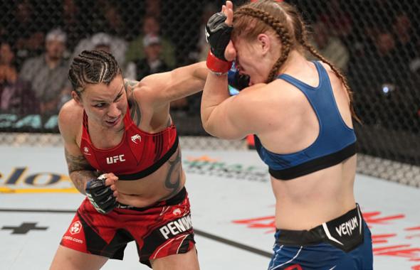 Raquel Pennington punches Aspen Ladd in their bantamweight fight during the UFC 273 event at VyStar Veterans Memorial Arena on April 09, 2022 in Jacksonville, Florida. (Photo by Jeff Bottari/Zuffa LLC)