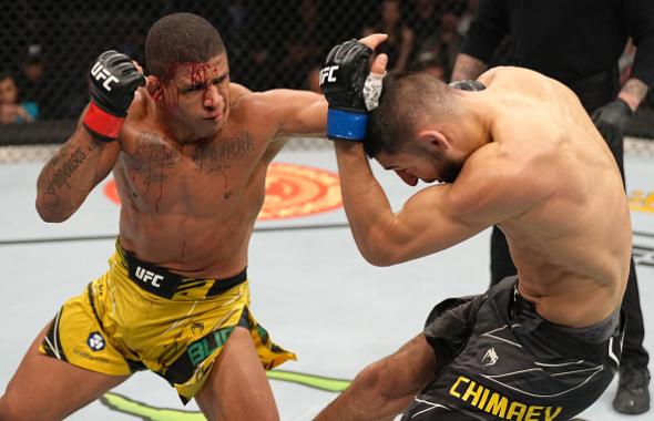 Gilbert Burns of Brazil punches Khamzat Chimaev of Russia in their welterweight fight during the UFC 273 event at VyStar Veterans Memorial Arena on April 09, 2022 in Jacksonville, Florida. (Photo by Jeff Bottari/Zuffa LLC)