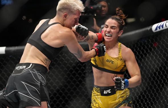 Norma Dumont of Brazil punches Macy Chiasson in a featherweight fight during the UFC 274 event at Footprint Center on May 07, 2022 in Phoenix, Arizona. (Photo by Jeff Bottari/Zuffa LLC)