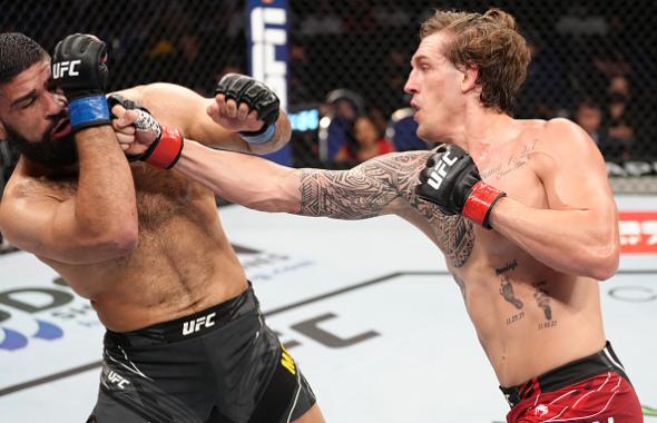 Brendan Allen punches Jacob Malkoun of Australia in a middleweight fight during the UFC 275 event at Singapore Indoor Stadium on June 12, 2022 in Singapore. (Photo by Jeff Bottari/Zuffa LLC)