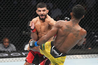 Amir Albazi of Iraq punches Francisco Figueiredo of Brazil in a flyweight fight during the UFC 278 event at Vivint Arena on August 20, 2022 in Salt Lake City, Utah. (Photo by Josh Hedges/Zuffa LLC)