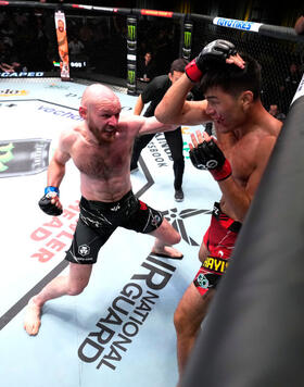 Viacheslav Borshchev of Russia punches Maheshate of China in a lightweight fight during the UFC Fight Night event at UFC APEX on May 20, 2023 in Las Vegas, Nevada. (Photo by Chris Unger/Zuffa LLC)