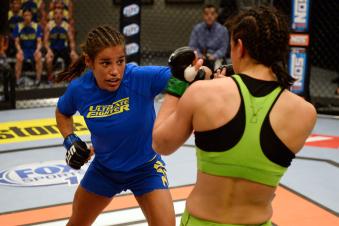 LAS VEGAS, NV - JUNE 6:  (L-R) Julianna Pena punches Shayna Baszler in their preliminary fight during filming of season eighteen of The Ultimate Fighter on June 6, 2013 in Las Vegas, Nevada. (Photo by Al Powers/Zuffa LLC via Getty Images) 