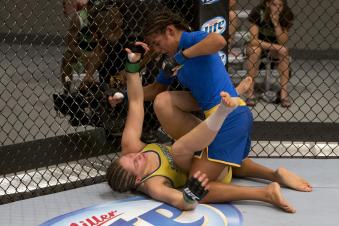 LAS VEGAS, NV - JULY 02:  (R-L) Julianna Pena punches Sarah Moras in their semifinal fight during filming of season eighteen of The Ultimate Fighter on July 2, 2013 in Las Vegas, Nevada. (Photo by Josh Hedges/Zuffa LLC via Getty Images) 