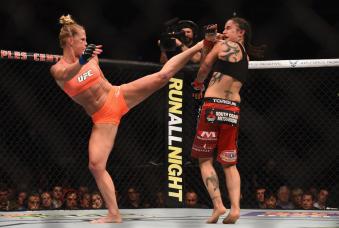 Holly Holm throws a kick at Raquel Pennington n their women's bantamweight bout during the UFC 184 event at Staples Center on February 28, 2015 in Los Angeles, California.