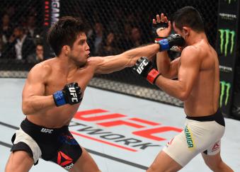 MONTERREY, MEXICO - NOVEMBER 21: (L-R) Henry Cejudo of the United States punches Jussier Formiga of Brazil in their flyweight bout during the UFC Fight Night event at Arena Monterrey on November 21, 2015 in Monterrey, Mexico. (Photo by Jeff Bottari/Zuffa LLC/Zuffa LLC via Getty Images)