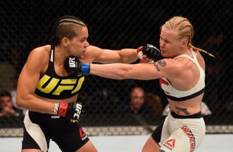 Amanda Nunes punches Valentina Shevchenko in their women's bantamweight bout during the UFC 196 event inside MGM Grand Garden Arena on March 5, 2016 in Las Vegas, Nevada.