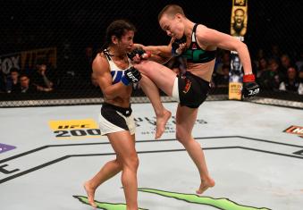 TAMPA, FL - APRIL 16:  (R-L) Rose Namajunas knees Tecia Torres in their women's strawweight bout during the UFC Fight Night event at Amalie Arena on April 16, 2016 in Tampa, Florida. (Photo by Jeff Bottari/Zuffa LLC via Getty Images)