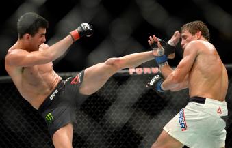 Dominick Cruz kicks Urijah Faber in their UFC bantamweight championship bout during the UFC 199 event at The Forum on June 4, 2016 in Inglewood, California.