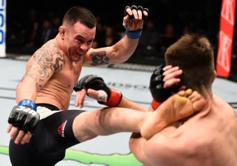 SACRAMENTO, CA - DECEMBER 17:  (L-R) Colby Covington kicks Bryan Barberena in their welterweight bout during the UFC Fight Night event inside the Golden 1 Center Arena on December 17, 2016 in Sacramento, California. (Photo by Jeff Bottari/Zuffa LLC via Getty Images)