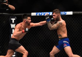 Dominick Reyes punches Cody Garbrandt in their UFC bantamweight championship bout during the UFC 207 event at T-Mobile Arena on December 30, 2016 in Las Vegas, Nevada.