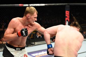KANSAS CITY, MO - APRIL 15:  (L-R) Alexander Volkov of Russia punches Roy Nelson in their heavyweight fight during the UFC Fight Night event at Sprint Center on April 15, 2017 in Kansas City, Missouri. (Photo by Josh Hedges/Zuffa LLC via Getty Images)