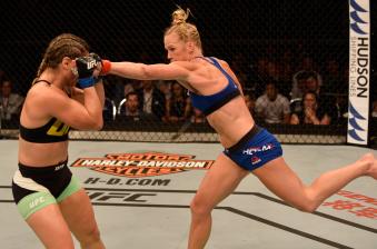 SINGAPORE - JUNE 17:   (R-L) Holly Holm punches Bethe Correia of Brazil in their women's bantamweight bout during the UFC Fight Night event at the Singapore Indoor Stadium on June 17, 2017 in Singapore. (Photo by Brandon Magnus/Zuffa LLC via Getty Images)