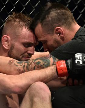 An emotional Tim Elliott talks with teammate James Krause in the Octagon after his victory over Mark De La Rosa during the UFC 219 event inside T-Mobile Arena on December 30, 2017 in Las Vegas, Nevada. Elliott's head coach Robert Follis passed away unexpectedly on December 15. (Photo by Brandon Magnus/Zuffa LLC)