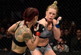 LAS VEGAS, NV - DECEMBER 30:  (R-L) Holly Holm punches Cris Cyborg of Brazil in their women's featherweight bout during the UFC 219 event inside T-Mobile Arena on December 30, 2017 in Las Vegas, Nevada. (Photo by Jeff Bottari/Zuffa LLC via Getty Images)