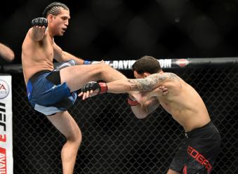 LAS VEGAS, NV - MARCH 03:   (L-R) Brian Ortega kicks Frankie Edgar in their featherweight bout during the UFC 222 event inside T-Mobile Arena on March 3, 2018 in Las Vegas, Nevada. (Photo by Brandon Magnus/Zuffa LLC via Getty Images)