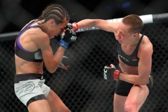 NEW YORK, NY - APRIL 07: UFC strawweight champion Rose Namajunas (R) lands a right hand to the head of Joanna Jedrzejczyk (L) during their UFC women's strawweight championship bout at UFC 223 at Barclays Center on April 7, 2018 in New York City. (Photo by Ed Mulholland/Getty Images)